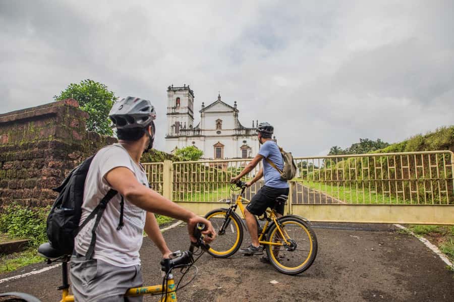 Goa: Old Goa and Divar Island E-Bike Tour with Snacks - Cycling Divar Island village roads: palms, paddy fields, ruins, and local rhythm